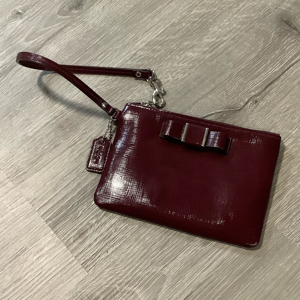 Coach Darcy patent bow wristlet in Sherry dark red